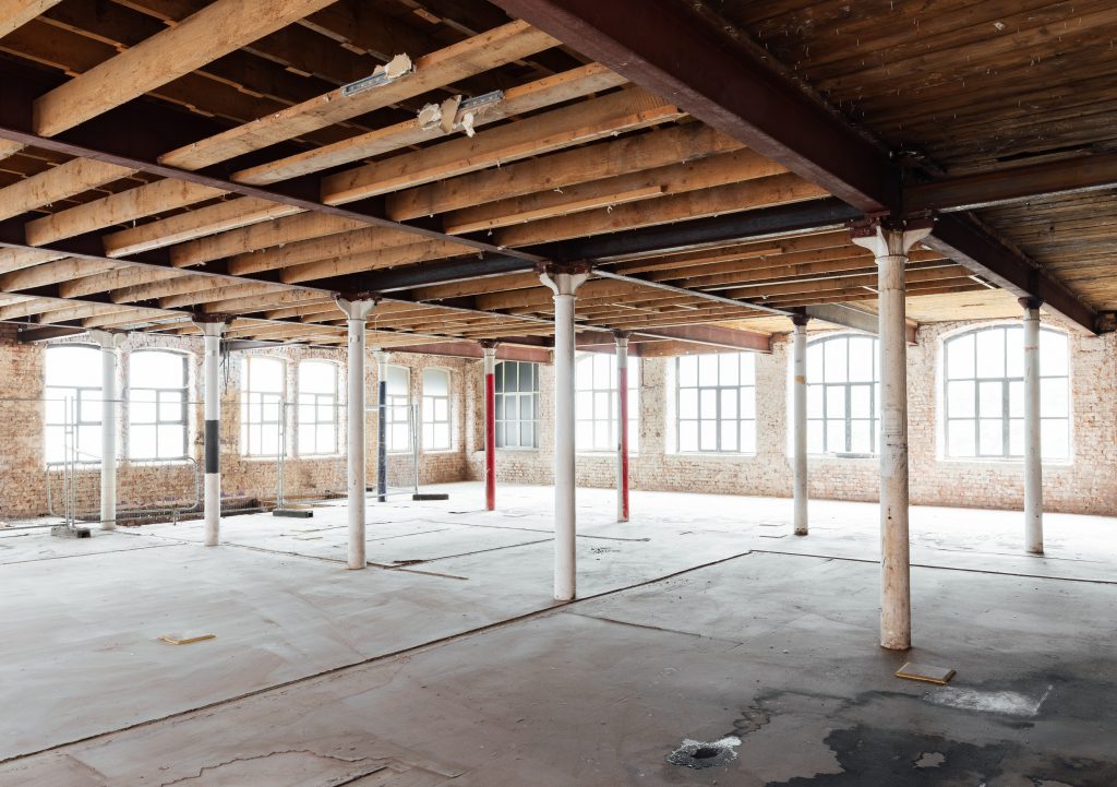 Old columns and exposed beams during build project at forthcoming apartment hotel at Cotton Yard Manchester   