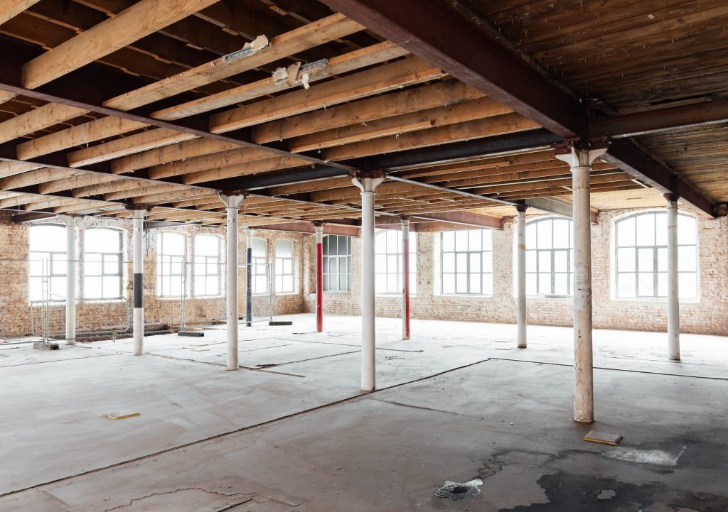 Old columns and exposed beams during build project at forthcoming apartment hotel at Cotton Yard Manchester