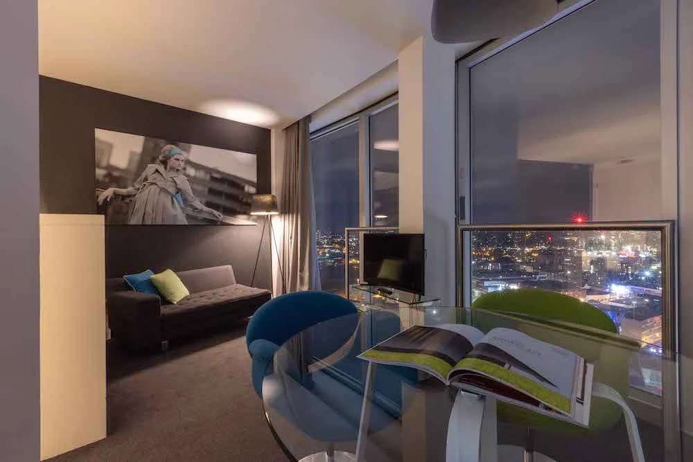 Staying Cool's Mini studio apartment living and dining area with stunning city views at night