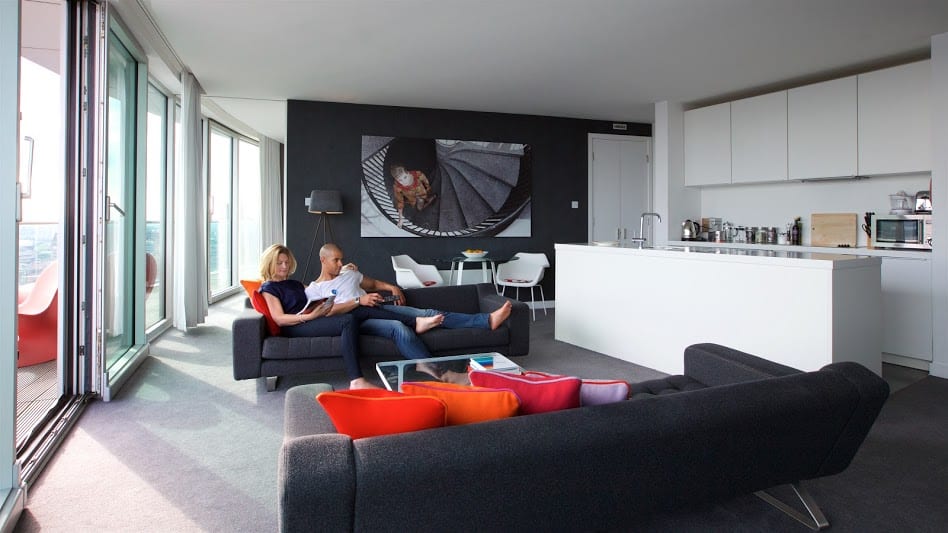 Couple relaxing on sofa in Rotunda aparthotel penthouse