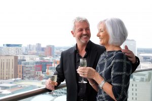 A couple enjoying their September Staycation views on staying cool's birmingham apart hotel balcony