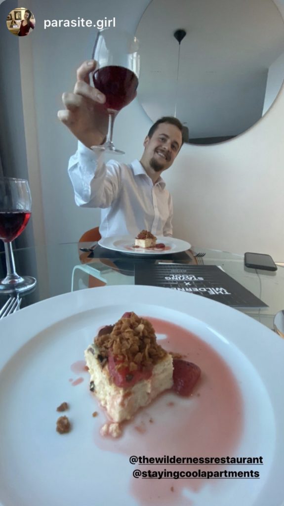 Guest toasting with glass of wine at wilderness private dining event at Rotunda.