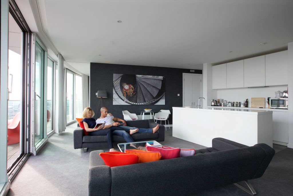 Couple relaxing on sofa in Staying Cool Penthouse at Rotunda - 72px