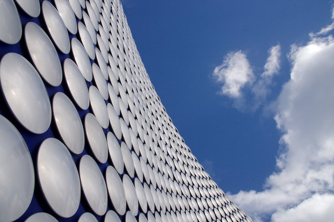 Exterior of Selfridges Birmingham store with blue sky and clouds