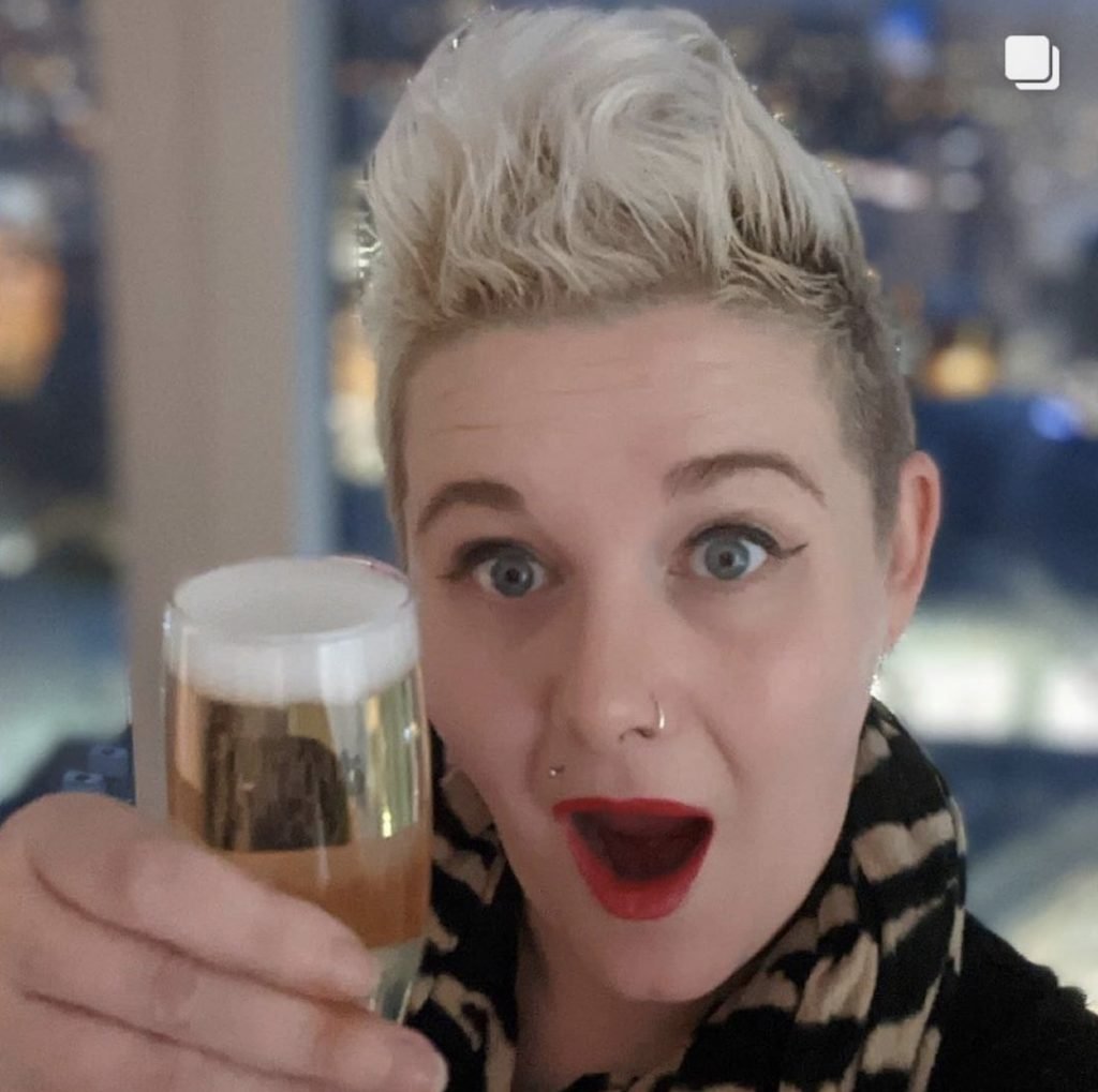 Guest holding up glass of champagne at The Wine Staycation event at Staying Cool's Rotunda Aparthotel