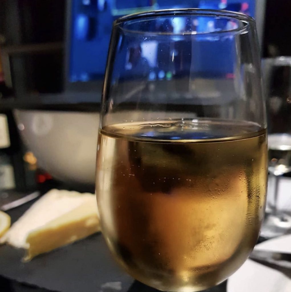 Glass of rose with cheese in the background at The Wine Staycation event at Staying Cool's Rotunda Aparthotel