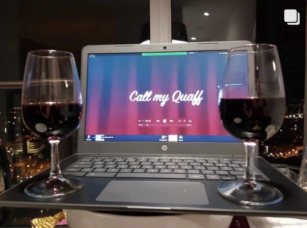 two glasses of red wine infront of the zoom call on screen at The Wine Staycation event at Staying Cool's Rotunda Aparthotel