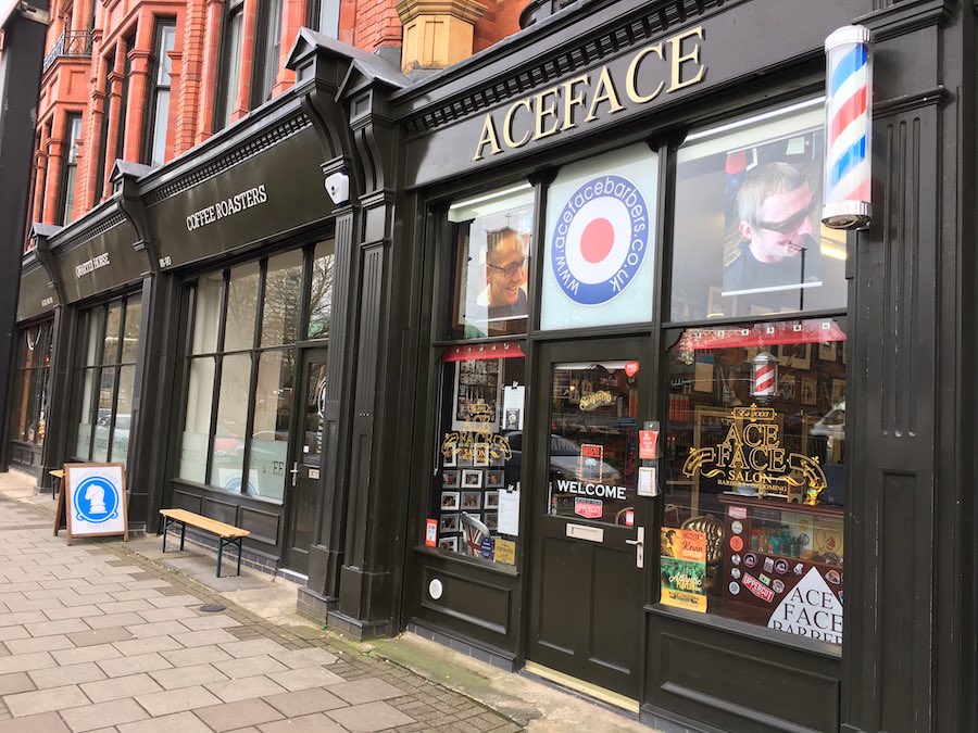Exterior facade of the traditional Ace Face Barber shop in Birmingham city centre.