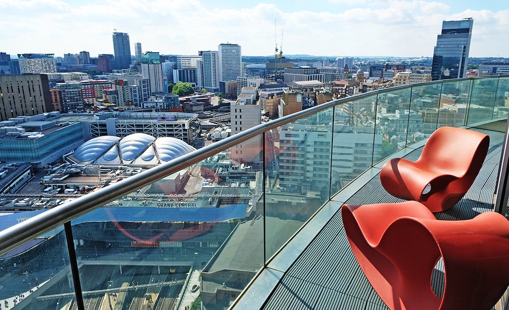 Blue skies and summer city views taken from Staying Cool's rotunda apart hotel penthouse balcony