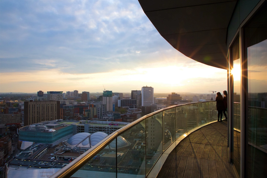 Friends enjoying the sunset from Staying Cool's penthouse apartment at rotunda birmingham