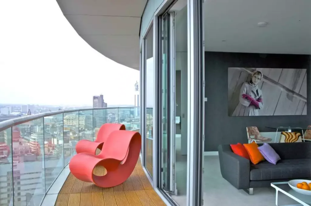 Red chairs on Staying Cool's apart hotel penthouse balcony at Rotunda Birmingham