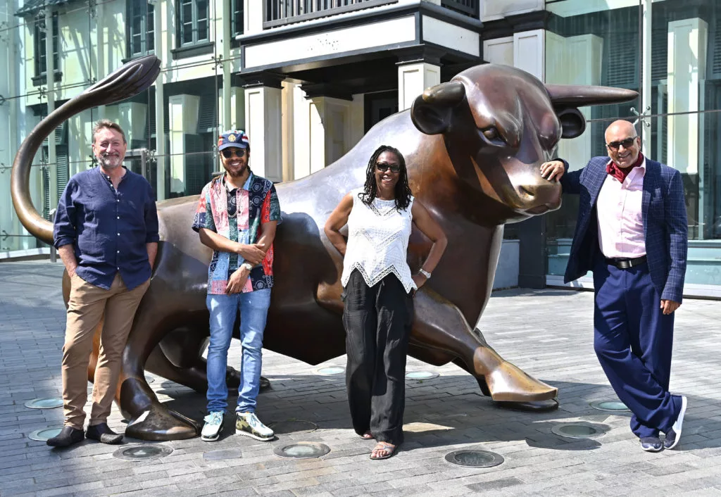 Birmingham 2022 common wealt games Creative Team: L-R Stephen Knight, Joshua ‘RTKal’ Holness, Maeve Clarke and Iqbal Khan standing infront of the Bullring Bull outside Staying Cool's rotunda apart hotel.